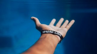 person wearing black silicone bracelet