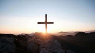 brown cross on brown rock during daytime